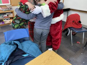 Children hugging Santa